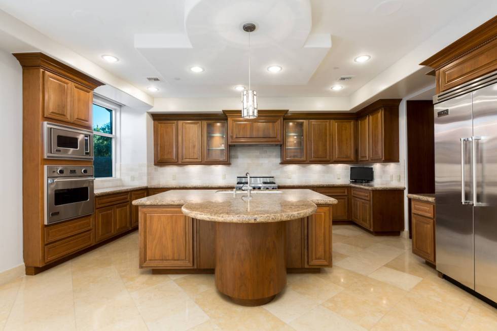 The kitchen has double ovens and a circular breakfast bar. (The Ivan Sher Group)
