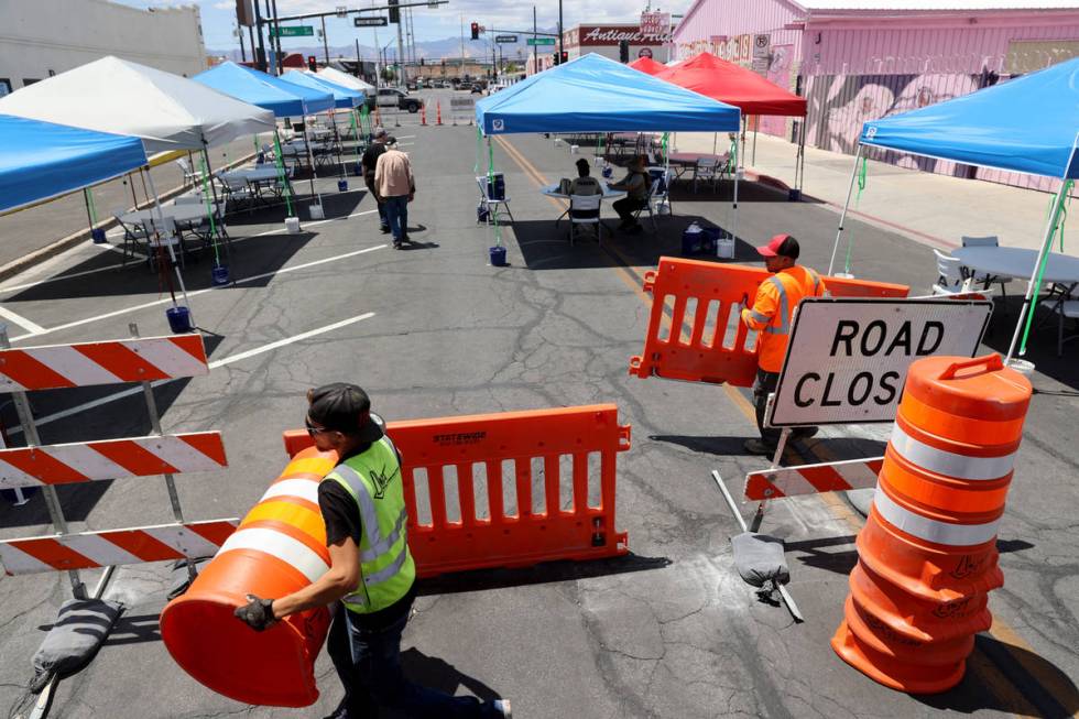 Eric Maldonado, left, and Ray Sandoval with of Work Zone Traffic Services, Inc. close Californi ...