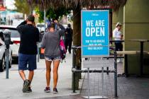 In this May 12, 2020 photo, customers walk past an open sign at Rubio's Coastal Grill on Tuesda ...