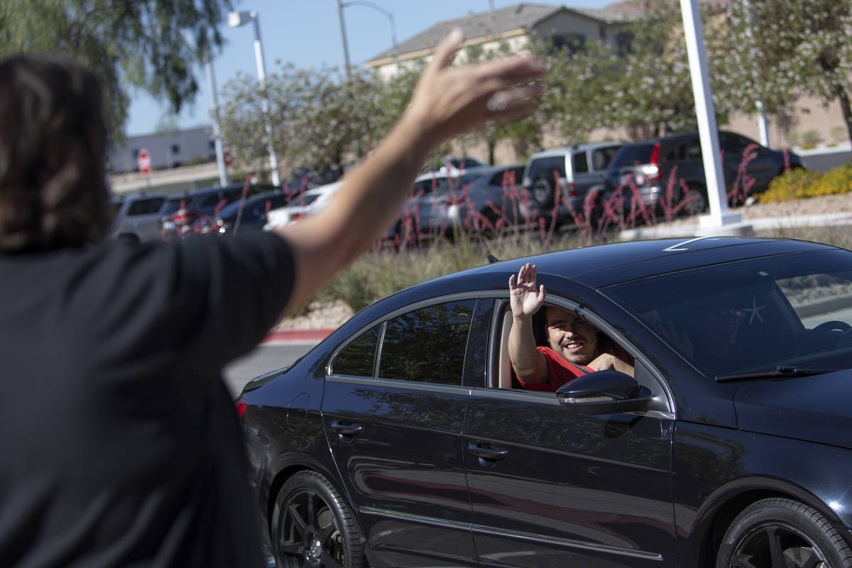 An Opportunity Village client waves to a staff member at Opportunity Village Ralph and Betty En ...