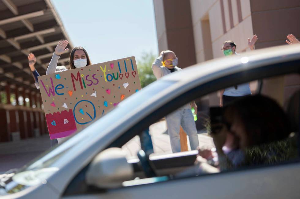 Opportunity Village staff wave to their clients at the Opportunity Village Ralph and Betty Enge ...