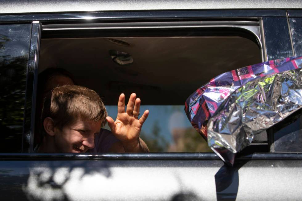 An Opportunity Village client and their family waves to staff members at Opportunity Village Ra ...