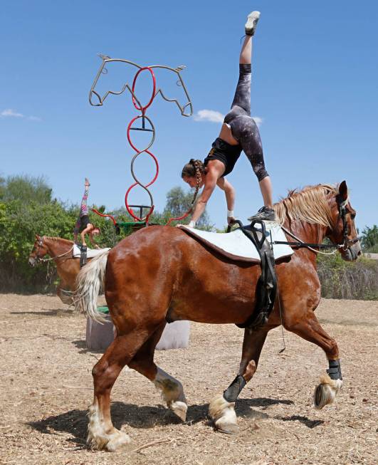 Gladius The Show performer Nicole England-Czyzewski, foreground, performs acrobatic stunts on C ...