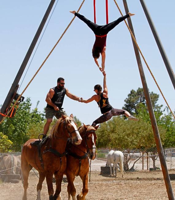 Gladius The Show co-owner Erik Martonovich, performs acrobatic stunts with performer Nicole Eng ...