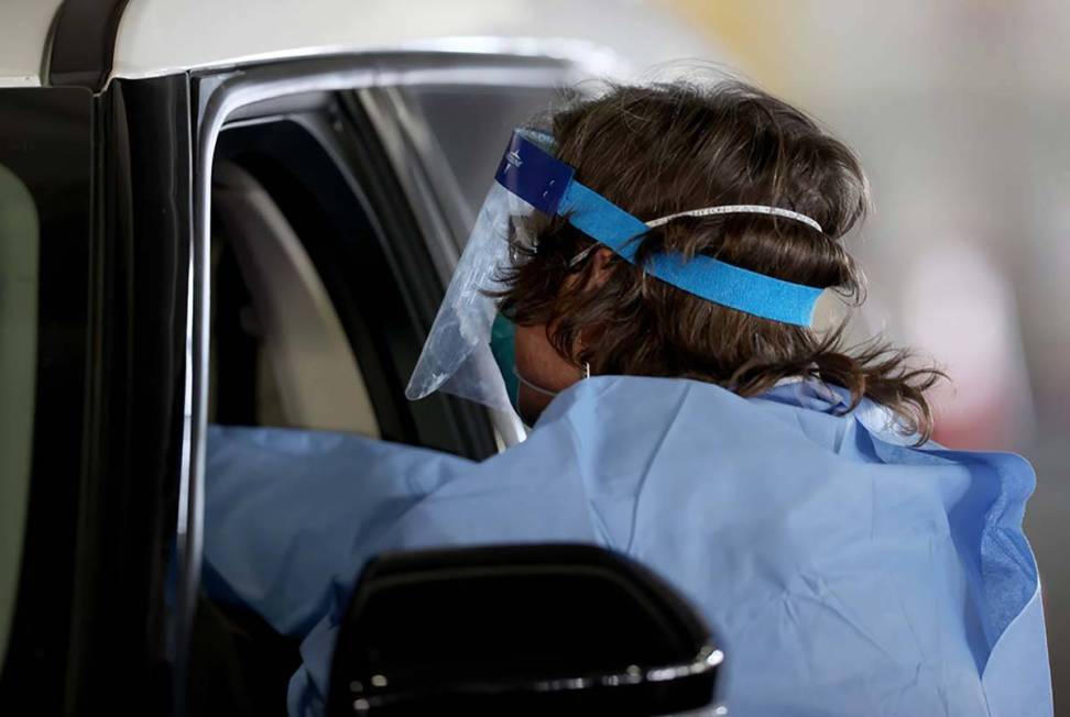 Registered nurse Megan Ryan works at the COVID-19 testing facility in the parking garage at The ...