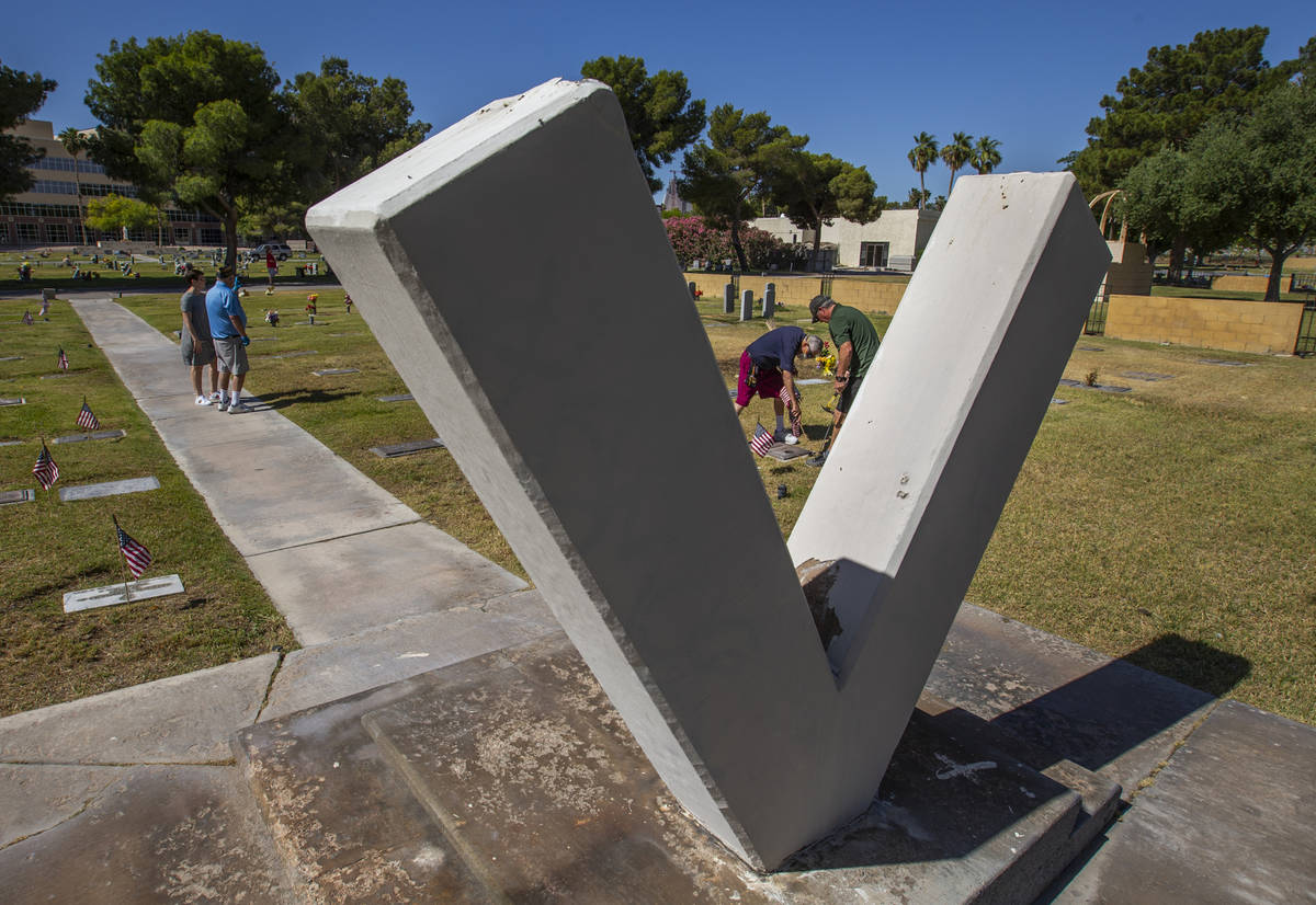 Mort Friedlander, right, and son Frank are framed by a "V" for veterans as they team ...