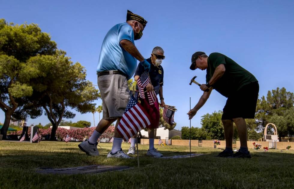 Steve Seiden, left, with Mort and Frank Friedlander team up to plant more American flags on vet ...