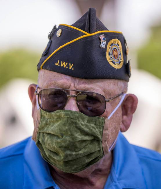 Retired Army Lt. Steve Seiden pauses while planting more American flags on veteran's graves in ...