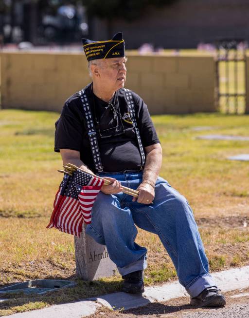 Army veteran Howard Greenspon takes a moment's rest while planting American flags on veteran's ...