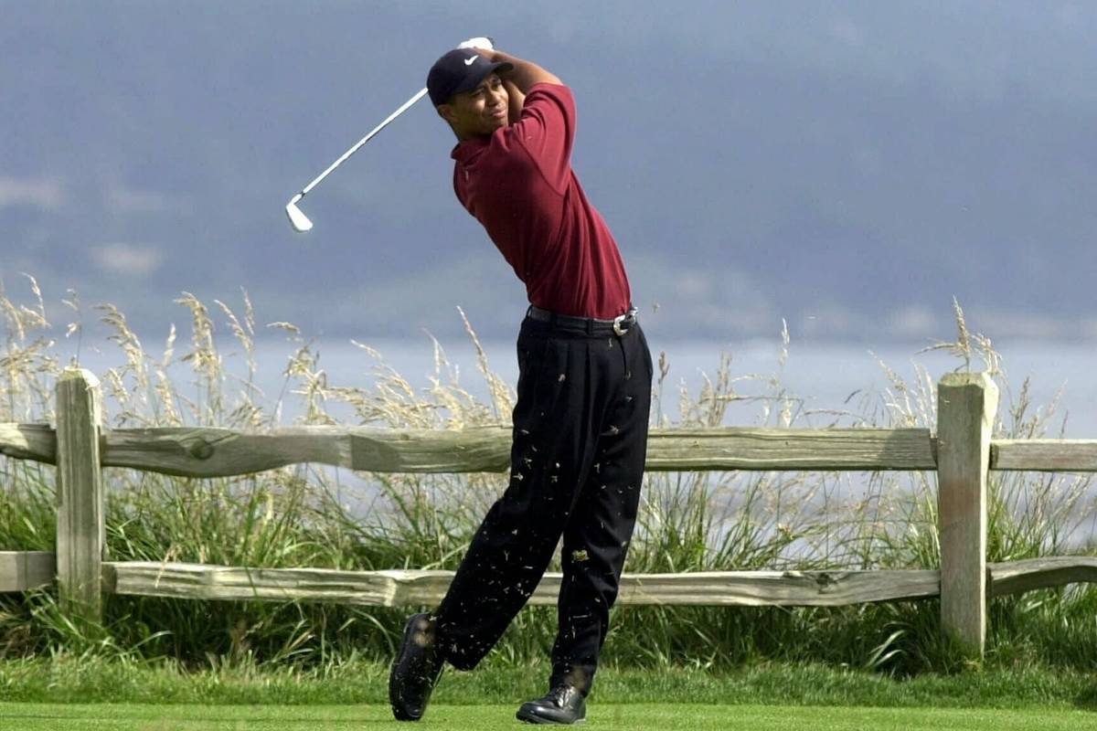 FILE - In this June 18, 2000, file photo, Tiger Woods tees off on the 18th hole on his way to w ...