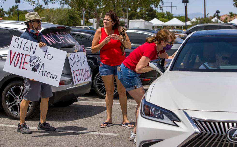 Henderson Coalition for Responsible Government volunteer David Sanchez, left, looks to Cindy Ha ...