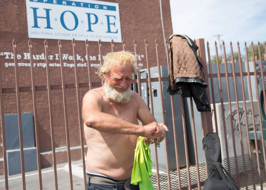 Tom Hagen washes his T-shirt outside The Courtyard Homeless Resource Center on Thursday, May 14 ...