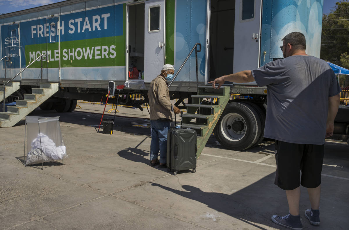 Kevin Williams, right, instructs a client on how to use the facilities as the Fresh Start Mobil ...
