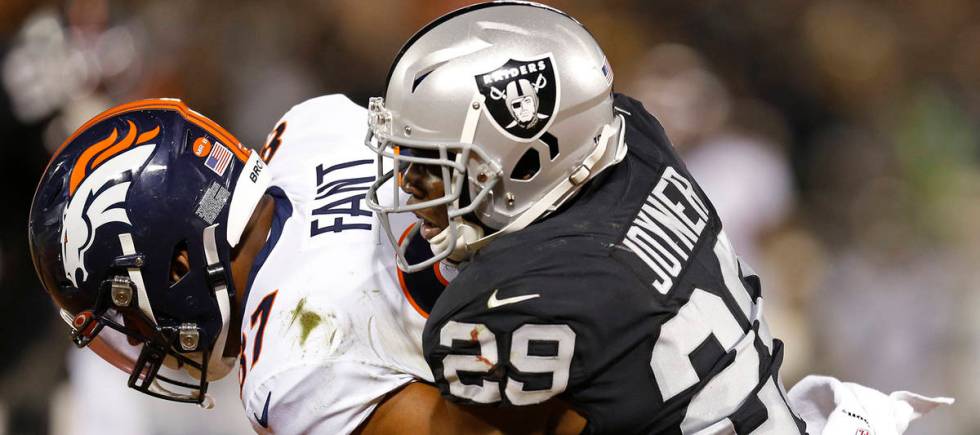 Denver Broncos tight end Noah Fant is stopped by Oakland Raiders free safety Lamarcus Joyner (2 ...