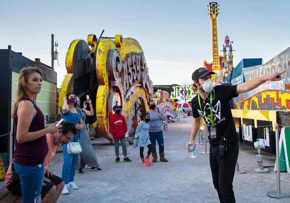 Interpreter Tyler Tingey, right, leads a tour at The Neon Museum on Friday, May 22, 2020, in La ...