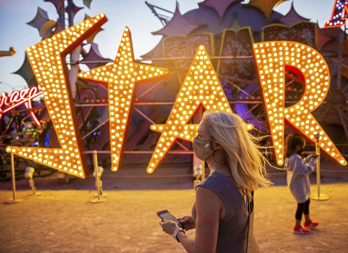 Heather Carpenter, left, takes a photo during a tour at The Neon Museum on Friday, May 22, 2020 ...