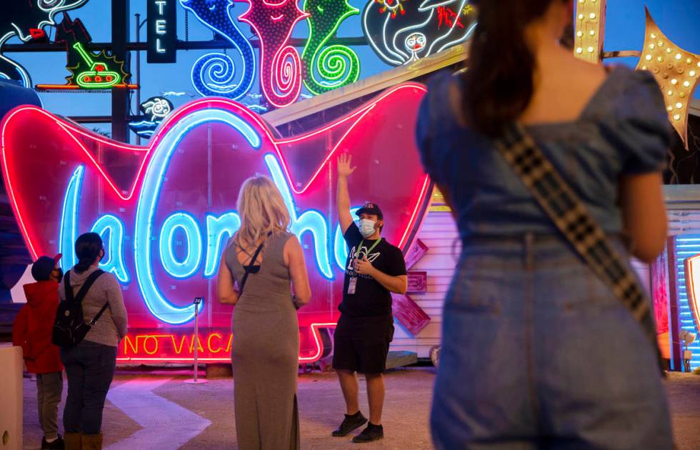 Interpreter Wyatt Currie, second from right, leads a tour at The Neon Museum on Friday, May 22, ...