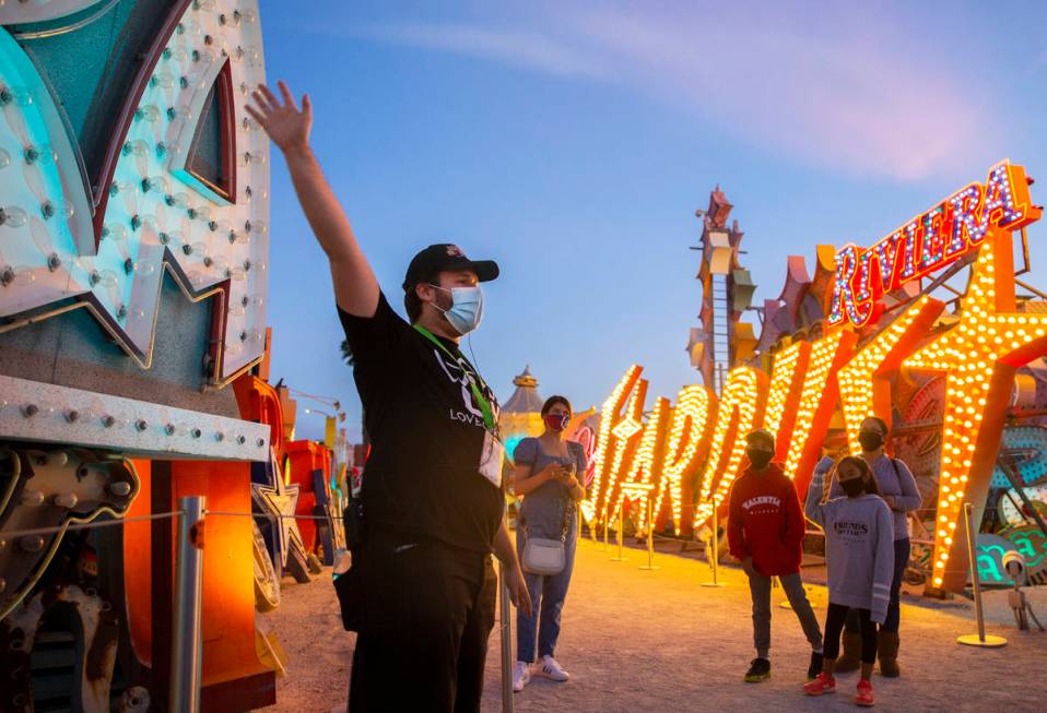 Interpreter Wyatt Currie, left, leads a tour at The Neon Museum on Friday, May 22, 2020, in Las ...