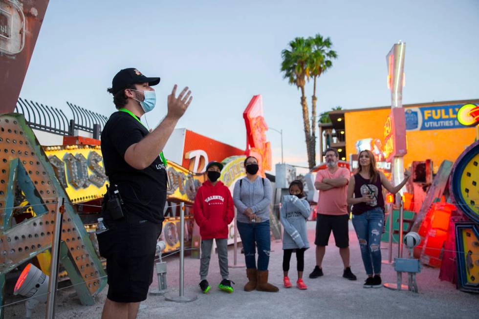 Interpreter Wyatt Currie, left, leads a tour at The Neon Museum on Friday, May 22, 2020, in Las ...