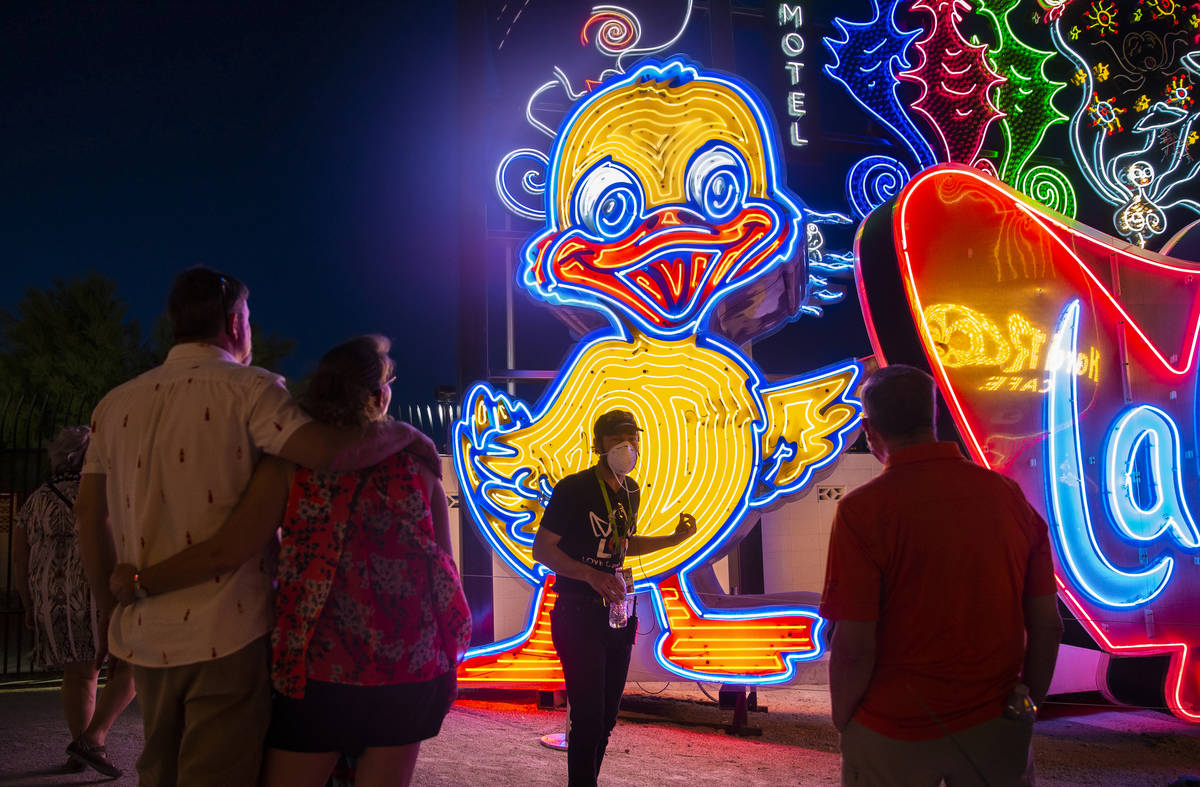 Interpreter Tyler Tingey, middle, leads a tour at The Neon Museum on Friday, May 22, 2020, in L ...