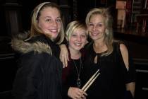 The Belk family, from left, Andress, Eliza and Megan, with drumsticks once used by their late f ...