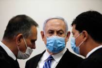 Israeli Prime Minister Benjamin Netanyahu, wearing a face mask in line with public health restr ...