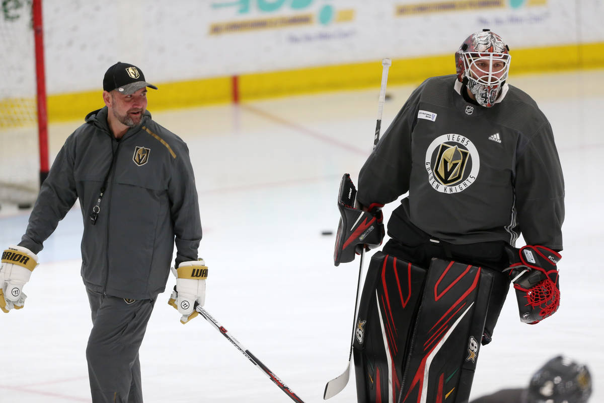 Vegas Golden Knights coach Peter DeBoer, left, talks to new team goaltender Robin Lehner during ...