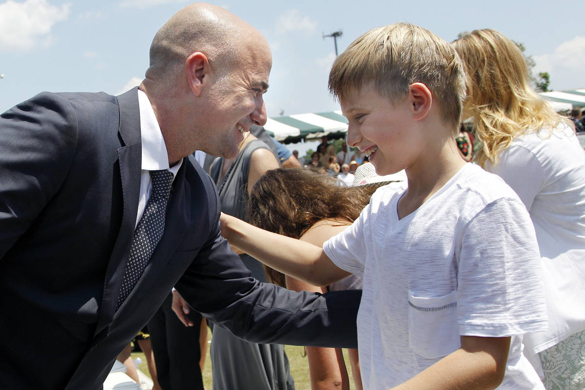 Tennis great Andre Agassi greets his son, Jaden, 9, after being inducted to the International T ...