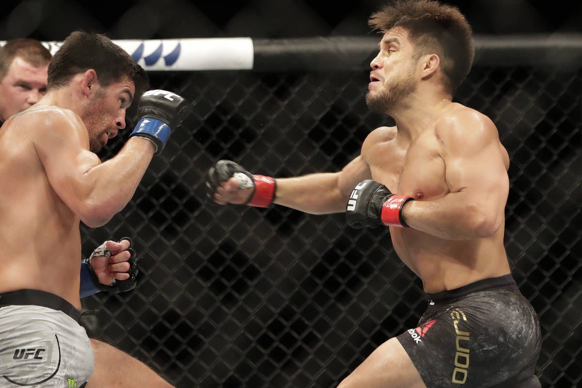 Henry Cejudo, right, punches Dominick Cruz during a UFC 249 mixed martial arts bout, Saturday, ...