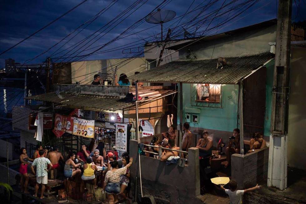 People gather outside a bar in Manaus, Brazil, Sunday, May 24, 2020, amid the new coronavirus p ...