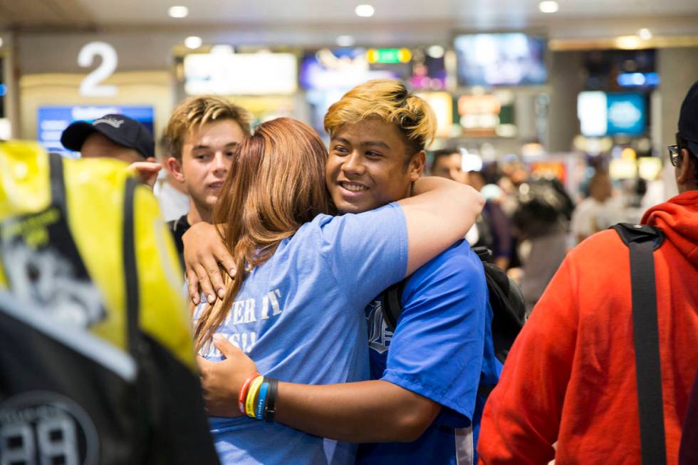 Jaime Riley, left, a mother of a player in the Southern Nevada Blue Sox baseball team, hugs tea ...