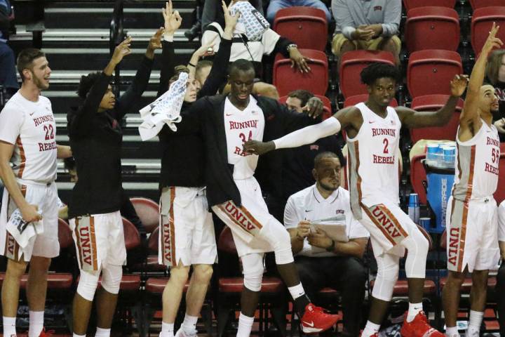 UNLV basketball players cheer for their teammates during the second half of their exhibition ga ...