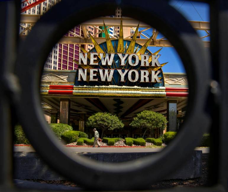 A landscaper blows clippings after trimming the bushes in front of New York-New York about the ...