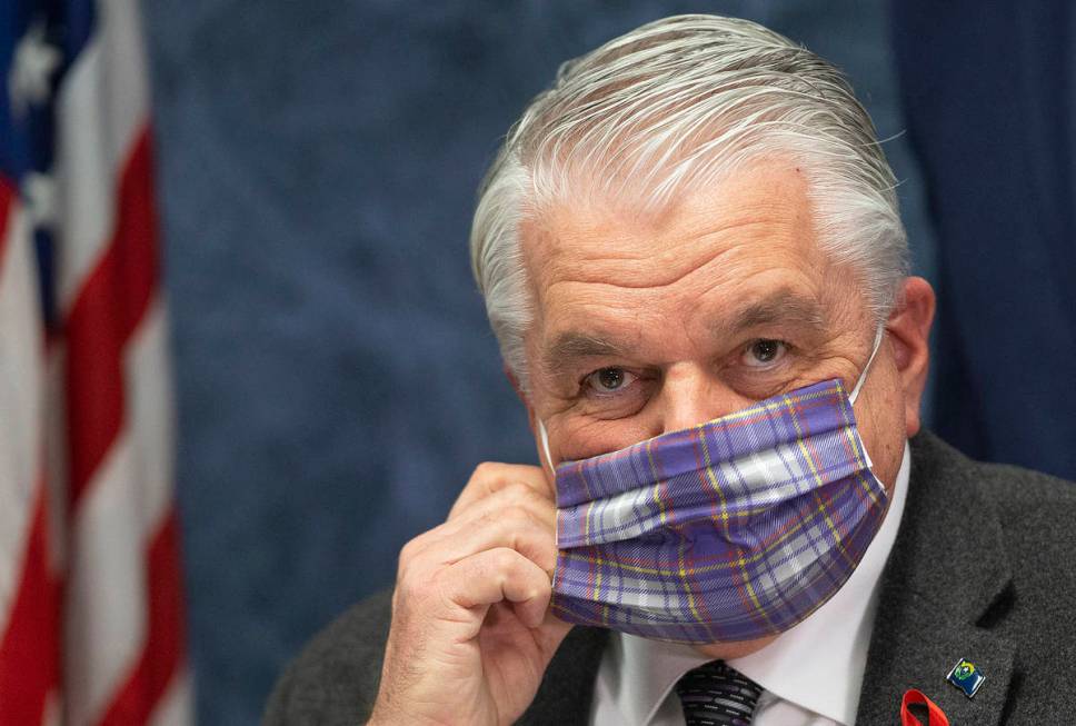 Gov. Steve Sisolak wears a protective mask before the start of a press conference, April 8, 202 ...