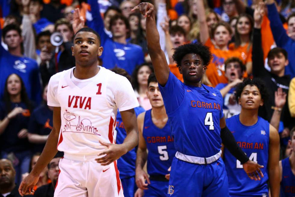 Bishop Gorman's Jonathan Braggs (4) watches his shot go in alongside Coronado's Jaden Hardy (1) ...