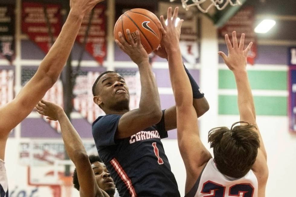 Coronado junior guard Jaden Hardy (1) drives past Liberty junior center Moliki Matavao (23) in ...