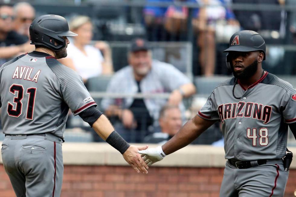 Arizona Diamondbacks' Alex Avila (31) celebrates with Abraham Almonte (48) after scoring off a ...