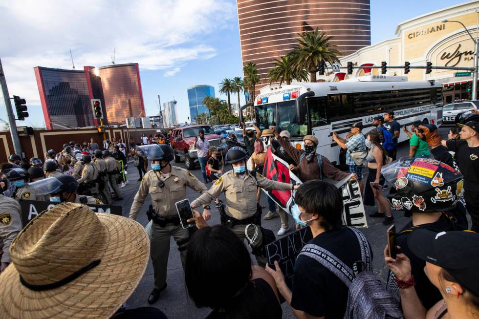 Demonstrators face off against police while demanding justice for George Floyd along the Las Ve ...