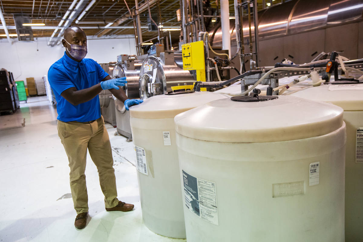 Alex Dixon, west region president of PureStar, shows some of the many disinfectants used for wa ...