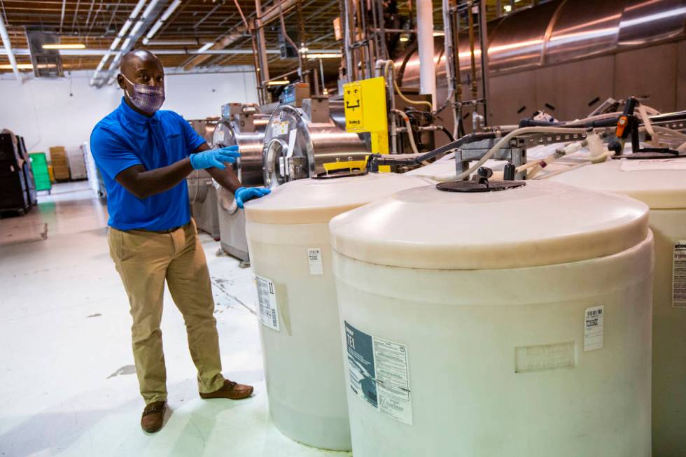 Alex Dixon, west region president of PureStar, shows some of the many disinfectants used for wa ...