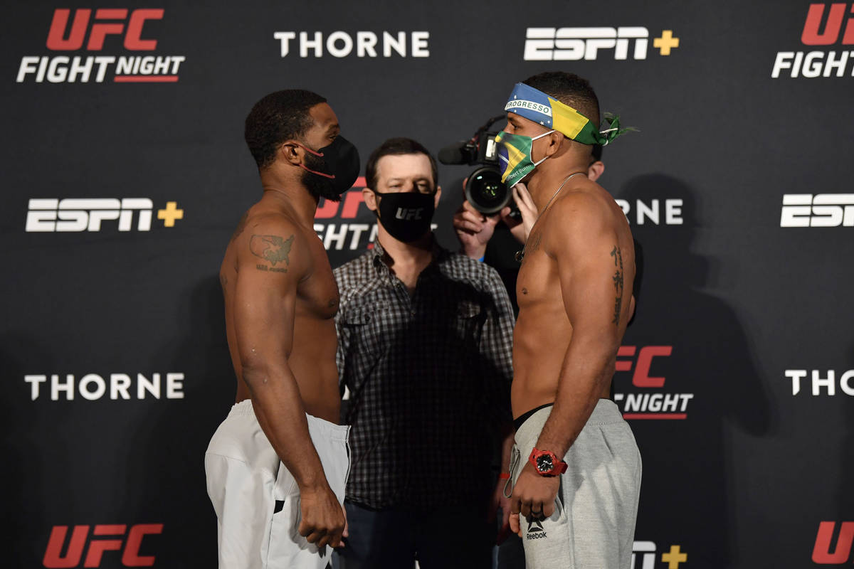 Opponents Tyron Woodley, left, and Gilbert Burns of Brazil face off during the UFC weigh-in at ...