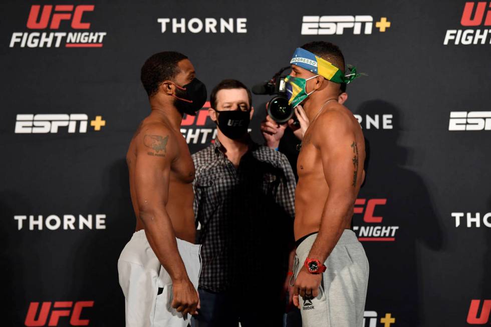 Opponents Tyron Woodley, left, and Gilbert Burns of Brazil face off during the UFC weigh-in at ...