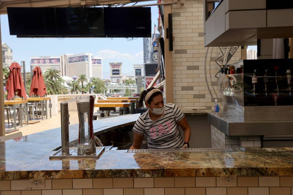 Gabriela Martinez cleans a bar at Beer Park at Paris Las Vegas on the Strip Thursday, May 28, 2 ...