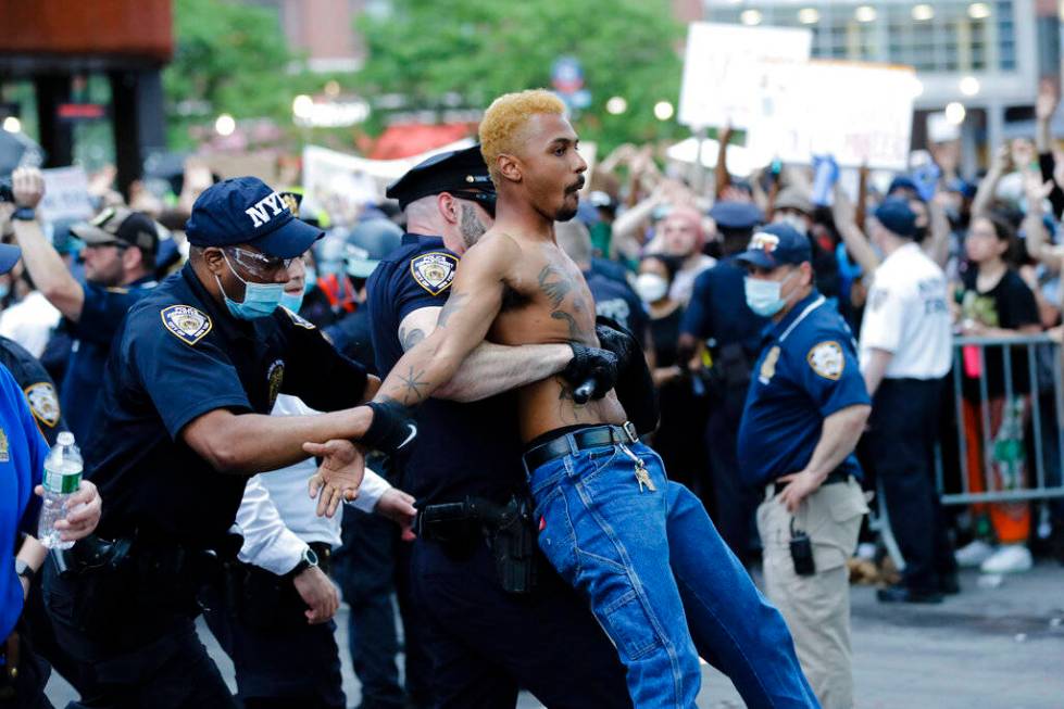 A protester is arrested during a rally at the Barclays Center over the death of George Floyd, a ...