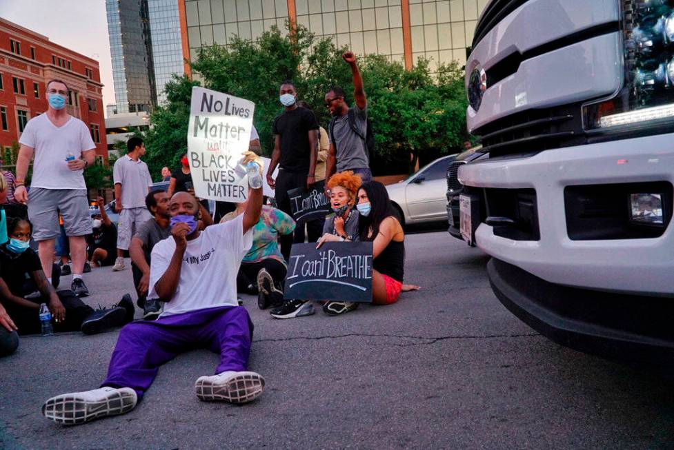 Donnell Ballard blocks traffic during a march in downtown Fort Worth, Texas on Friday, May 29, ...