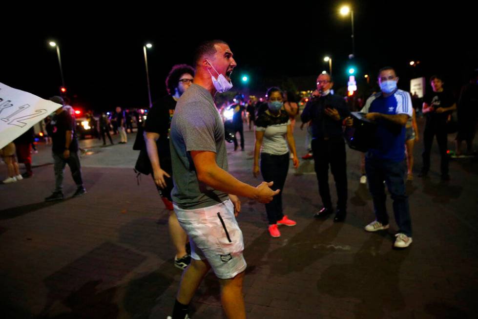 Protesters rally during a demonstration against police brutality in downtown Dallas, on Friday, ...