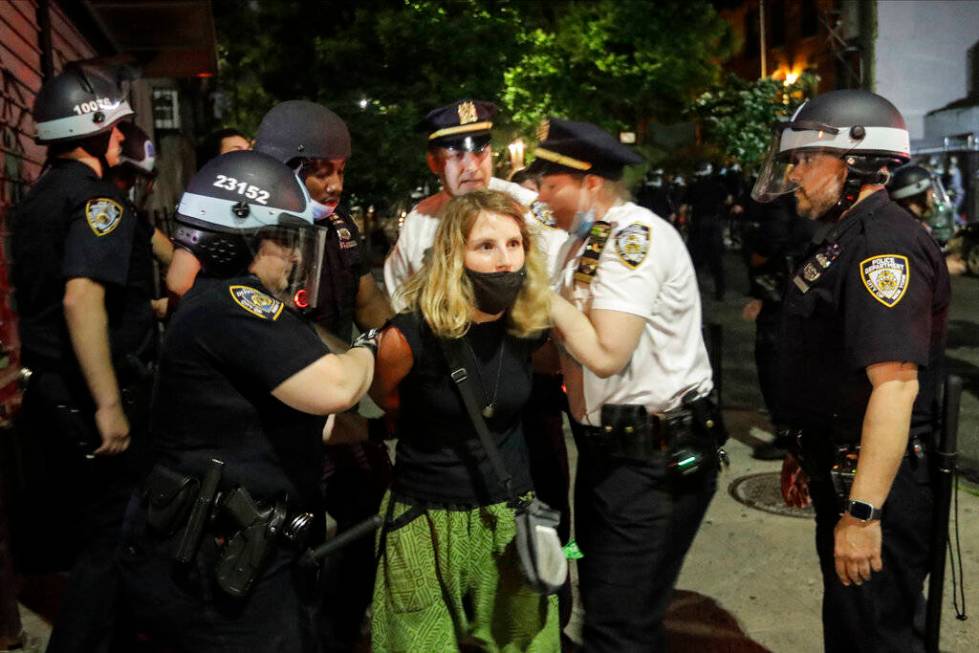 Police officers arrest protestors near Barclays Center after a rally over the death of George F ...