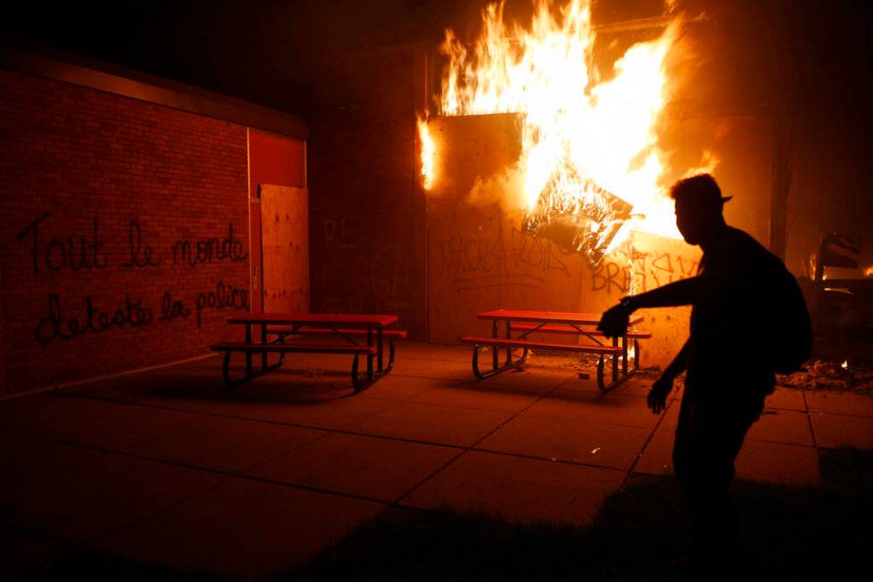 People set a fire during continued protest Friday, May 29, 2020, in Minneapolis. Protests conti ...