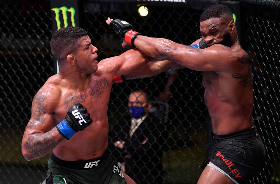 LAS VEGAS, NEVADA - MAY 30: (L-R) Gilbert Burns of Brazil punches Tyron Woodley in their welter ...