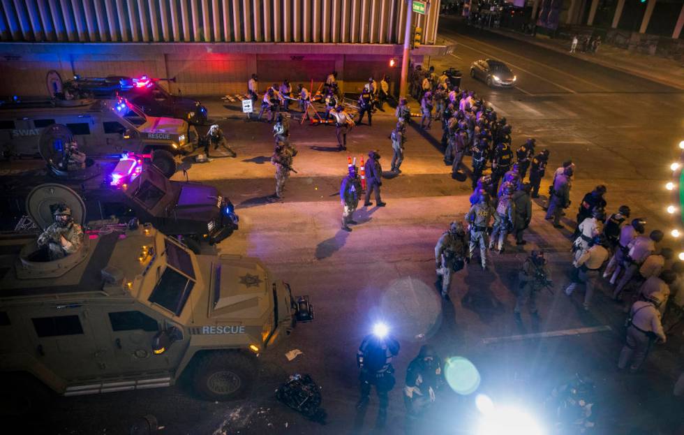 Las Vegas Police move down Las Vegas Blvd. towards protesters as chaos erupts during a Black Li ...